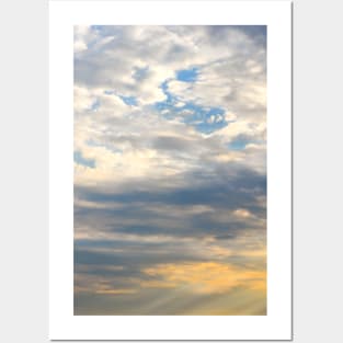 Beautiful sky at sunrise with yellow, blue and clouds Posters and Art